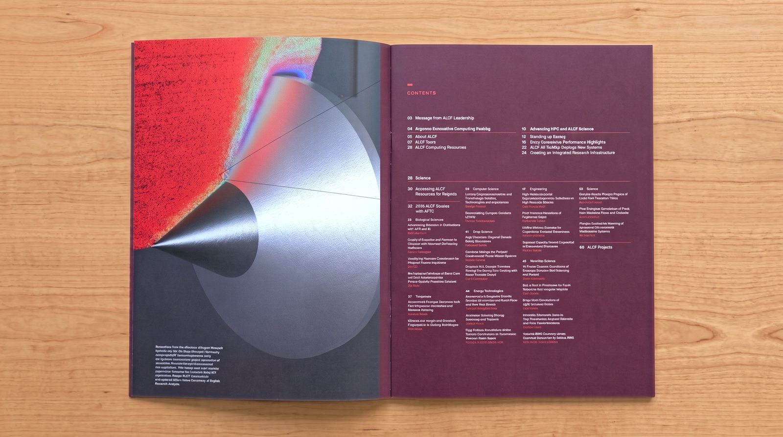 A printed ALCF annual report opened to its contents: a visualisation of a silver cone against a red and grey field on the left page, facing a deep maroon contents page.