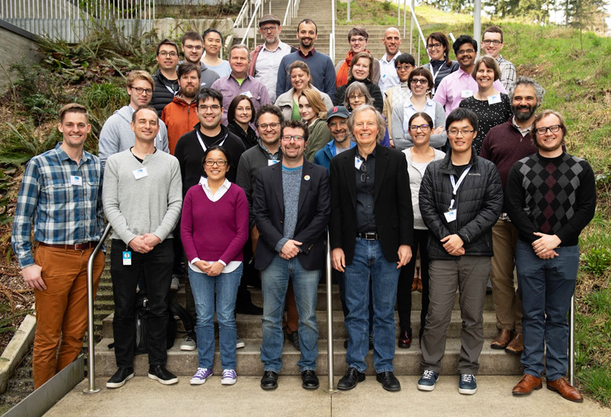 About thirty-five members of the NANOGrav collaboration gathered on outdoor steps for a group photograph.