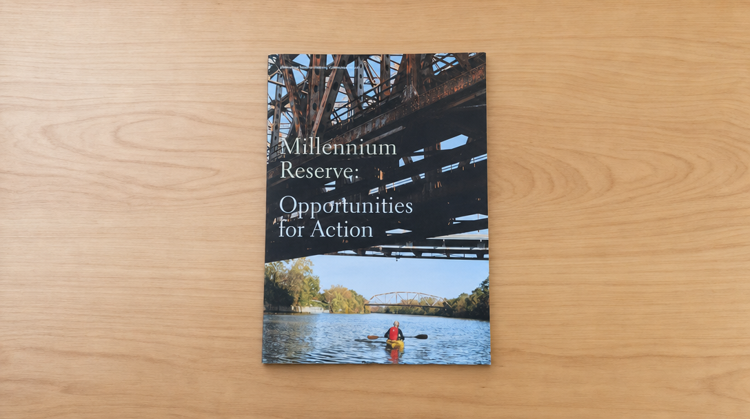 Cover of the report Millennium Reserve: Opportunities for Action, showing a kayaker paddling beneath a rusted steel bridge.